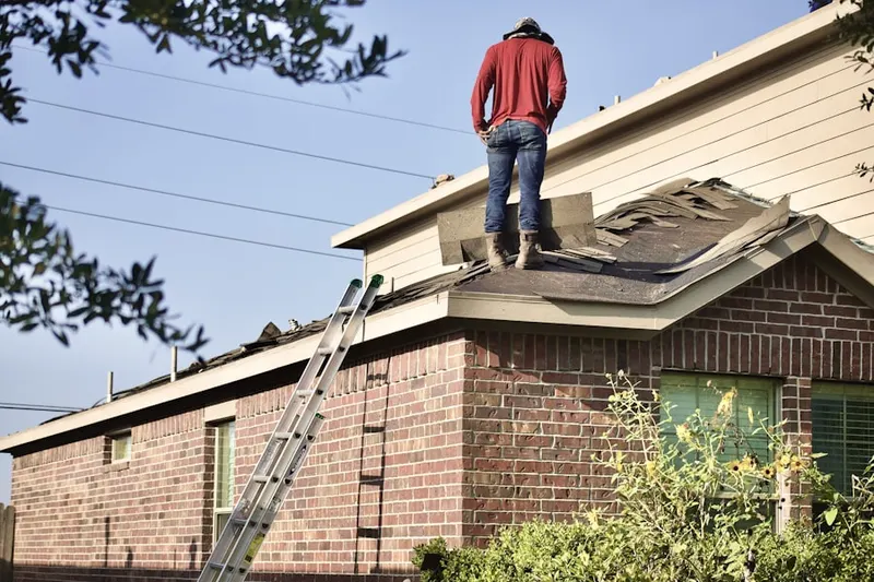 Professional roofer working on a residential roof in Abbeville